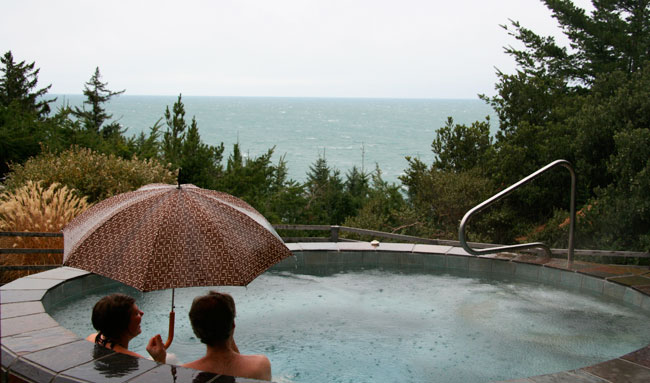 Photo fo couple in WildSpring spa with umbrella in rain